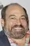 Danny Woodburn como Mr. Poulos