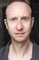 David Langham como Father Garret