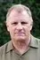 Gordon Clapp como Chaplain Orlovsky