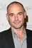 Paul Blackthorne como Quentin Lance